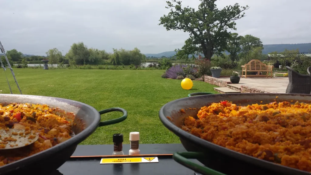 Authentic Spanish paella being cooked live at a company anniversary celebration in the grounds of a private country house.