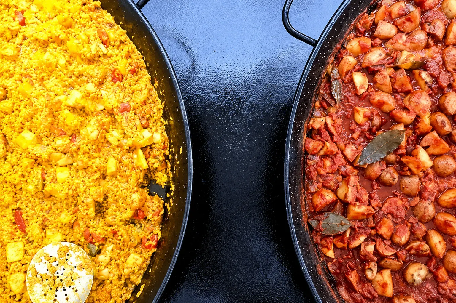 Chicken paella from our Paella Catering Menu along side a pan of Patatas Bravas
