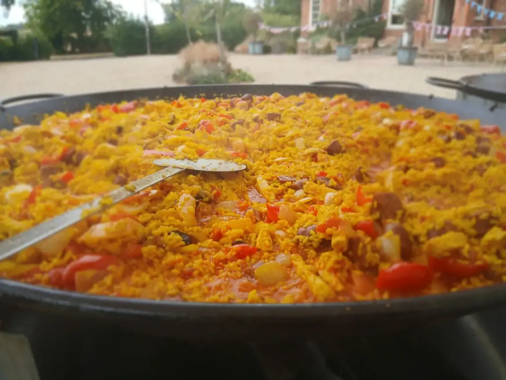 Guests enjoying paella at a pre-wedding party near Grantham