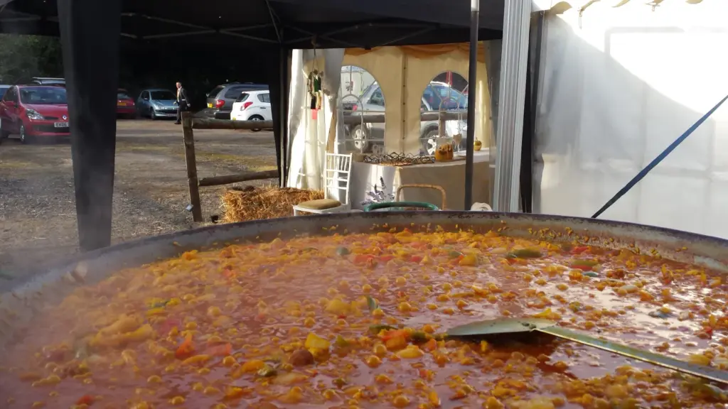 Wedding planning mistakes advice with fresh paella cooking at a marquee wedding