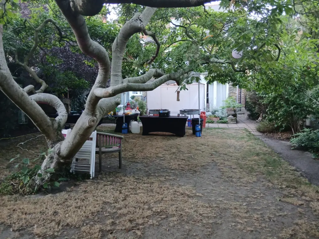 Long private garden prepared for an evening celebration